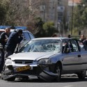 Israeli policemen inspect the car used by a Palestinian motorist to ram into a group of pedestrians in Jerusalem