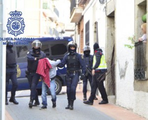 Spanish police officers arrest a man suspected of having links to Islamist militant activities during a police raid in Cebreros